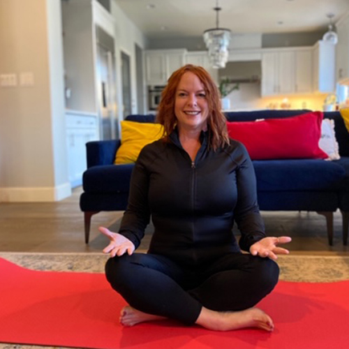 woman meditating on a red yoga mat