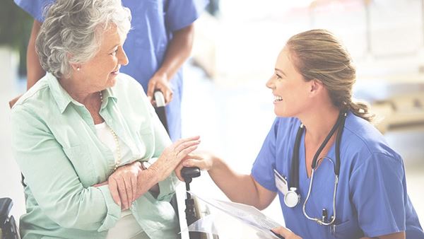 surgeon or doctor smiling at senior woman surgeon or doctor smiling at senior woman