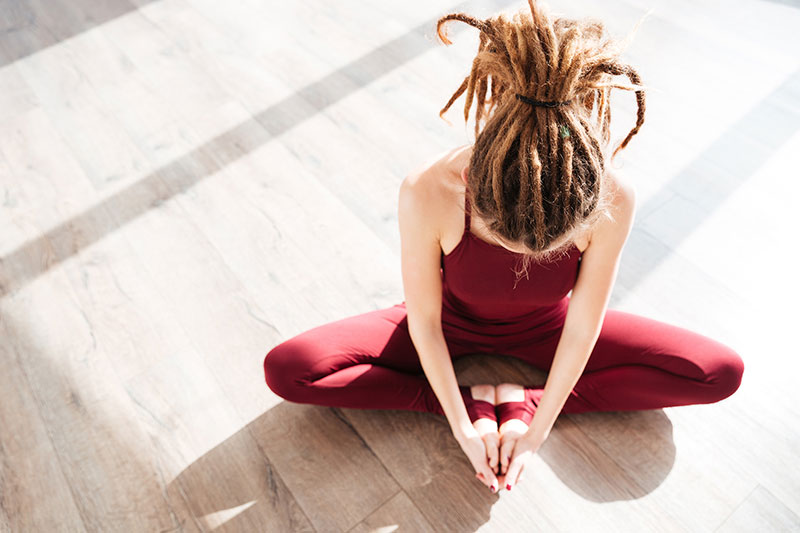 flexible woman with dreadlocks sitting flexible woman with dreadlocks sitting