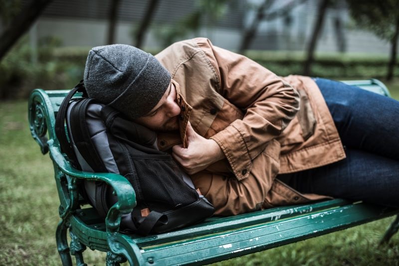homeless man on a bench