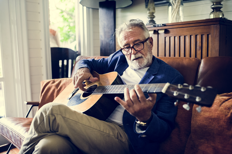 Elderly Man playing guitar