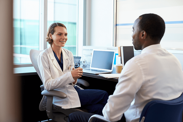 Doctor in consultation with male patient