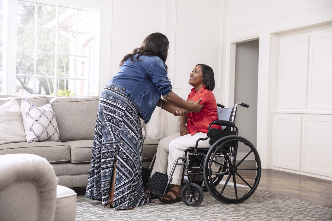 caregiver assisting patient in wheelchair