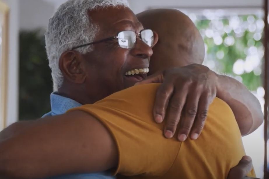 Father and adult son hugging