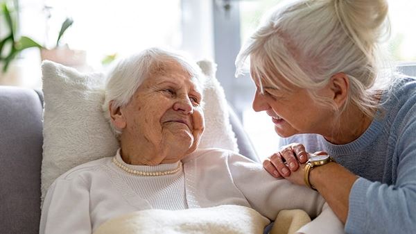 Mother and her daughter smiling at each other