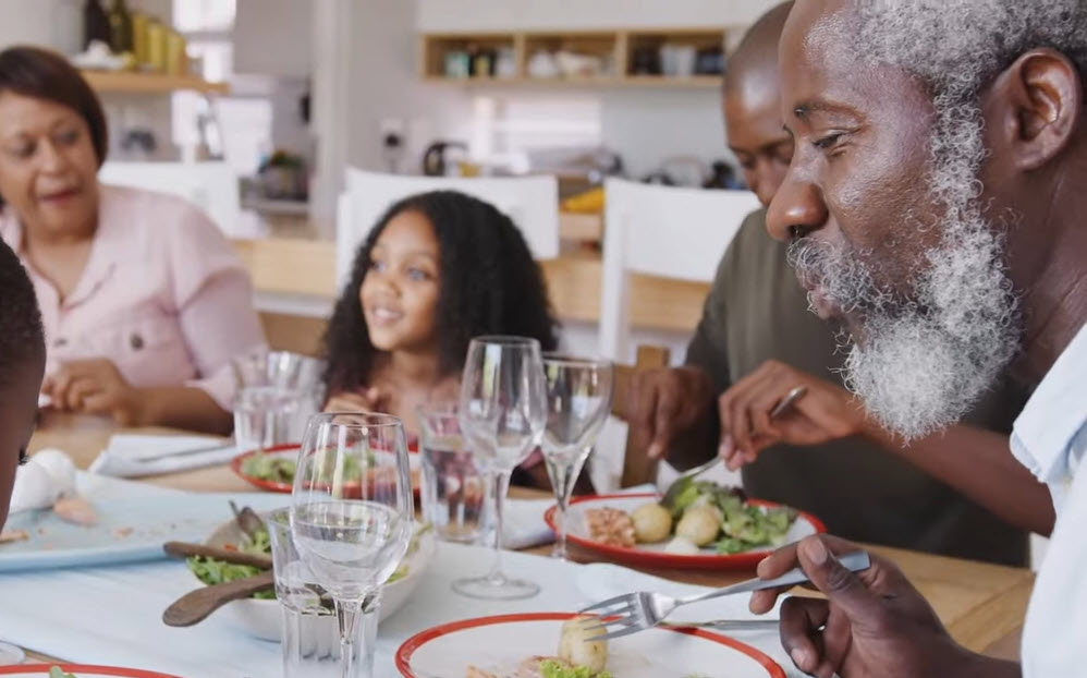 Multi-generational family having dinner at the table