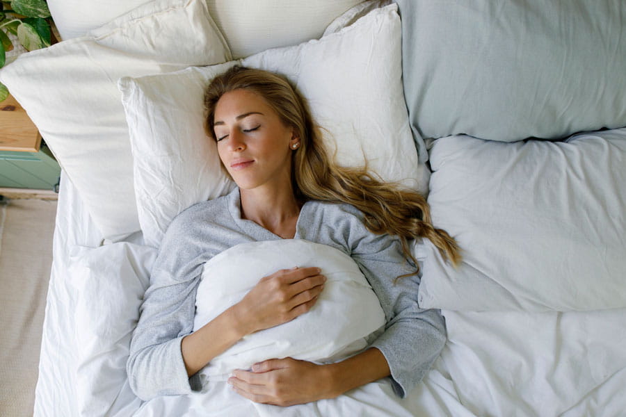 Young woman asleep in her bed