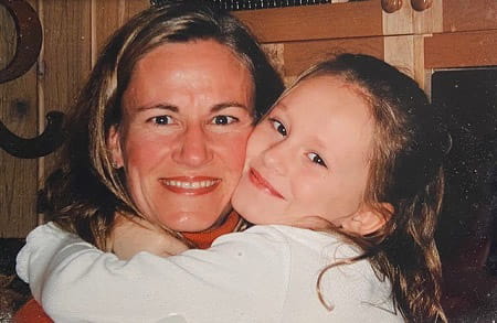 Isabella Zini being hugged by a young child Isabella Zini being hugged by a young child