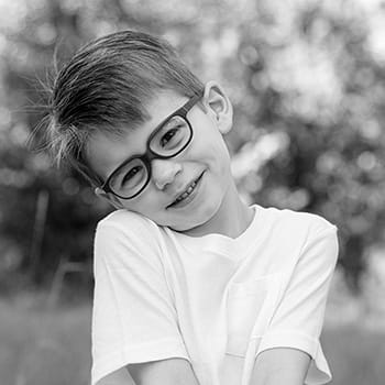 A black and white photo of Boden Cardio smiling in an outdoor setting