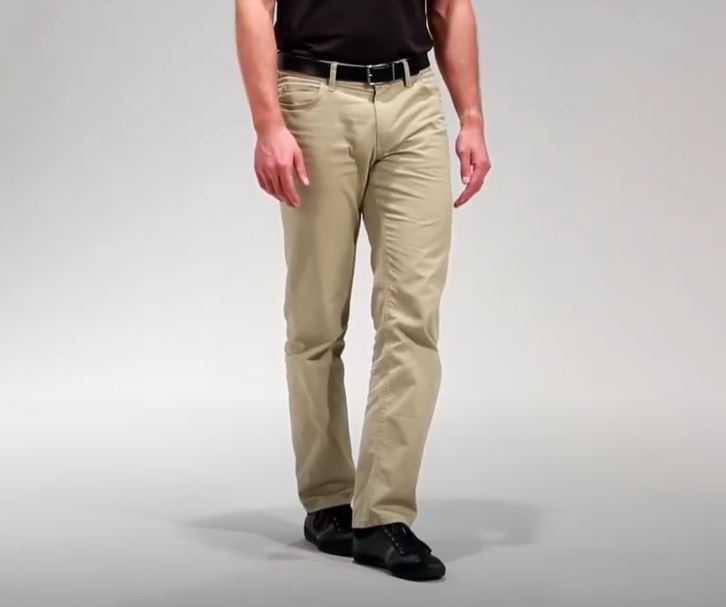 A person is standing with their left foot positioned directly in front of their right foot.