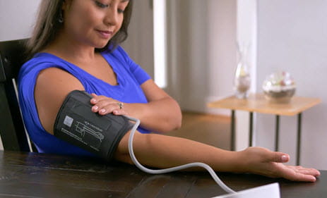 woman checking blood pressure at home