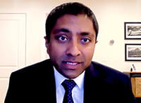 Hardik P. Amin, MD, talking on a video call from his office Dr. Amin talking on a video call in an office setting