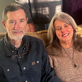 Kathie Johnson posing with her husband on a sofa Kathie Johnson posing with her husband on a sofa